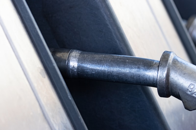 Fuel pump nozzle refueling a car