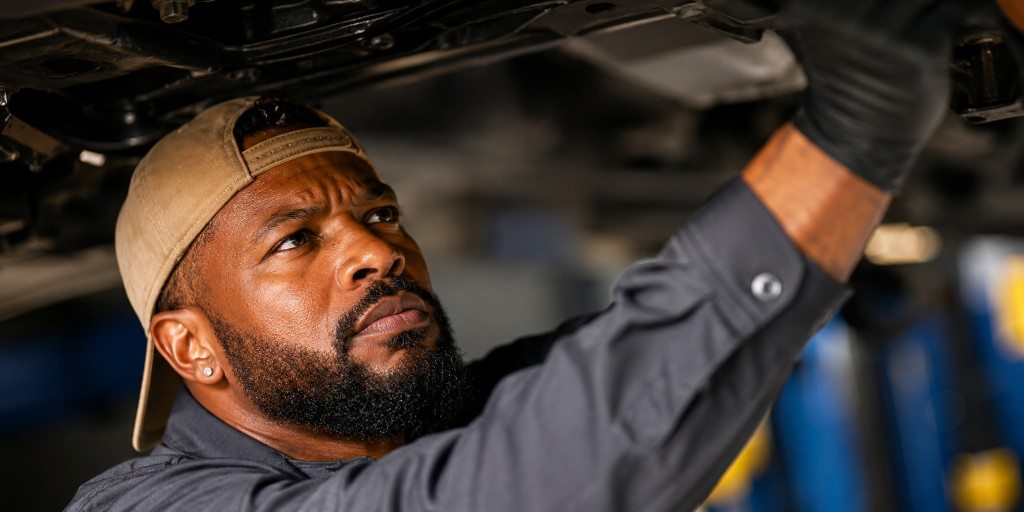 RayRay mechanic working under a vehicle during a mobile and roadside repair